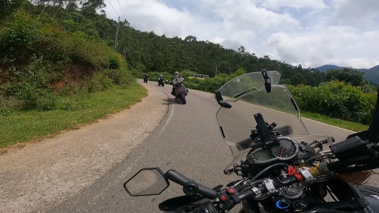 Finished edit: riders on a hairpin bend in the Munnar hills